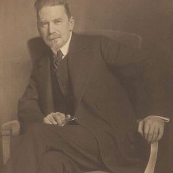 Nicola Persheid, Portrait of Heinrich Wölfflin, 1912, Basel, University's Library, Estate HW Man in formal suit sitting on a wooden chair, holding a pair of glasses.